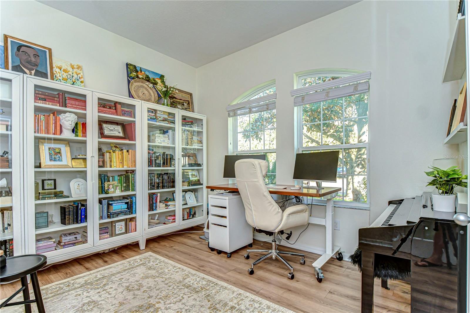 Discover your personal retreat in this serene home office, boasting large windows for ample natural light