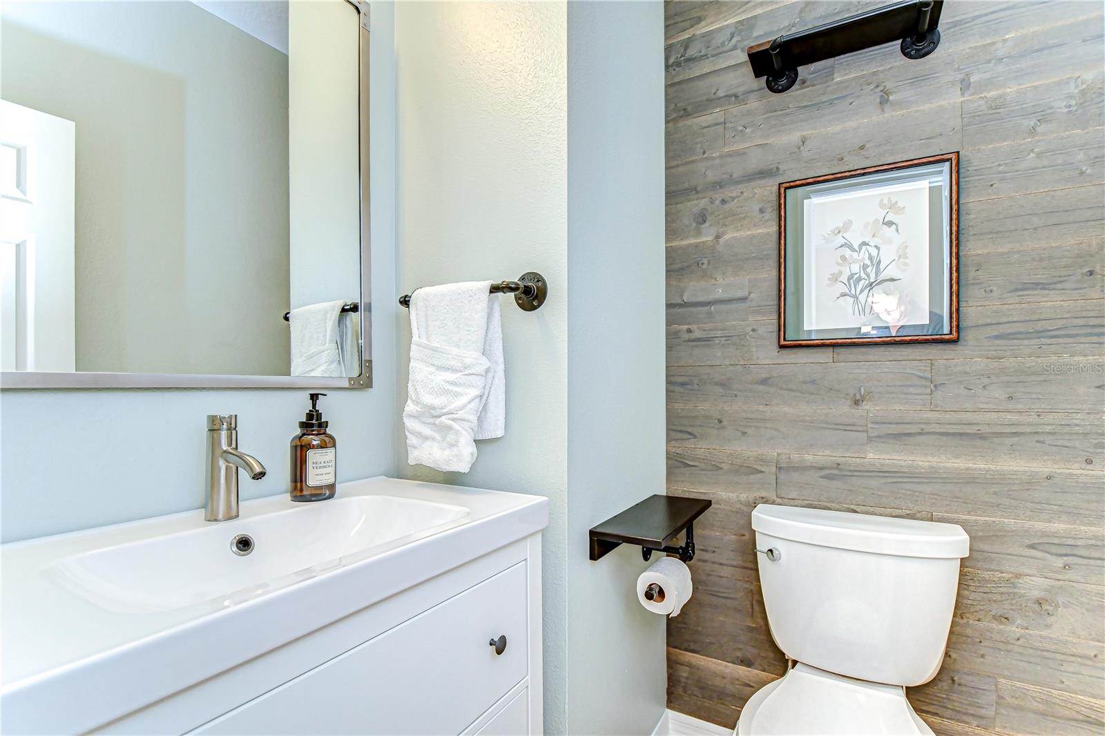 Discover your serene oasis in this beautifully designed bathroom featuring sleek fixtures, a modern vanity, and stylish wood accents.