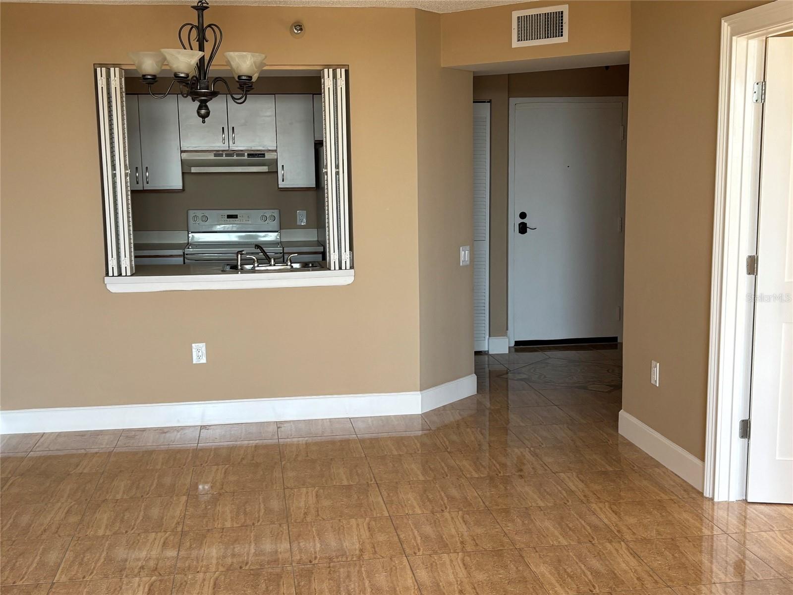 Living Room looking to the kitchen. Bedroom door is on the right.