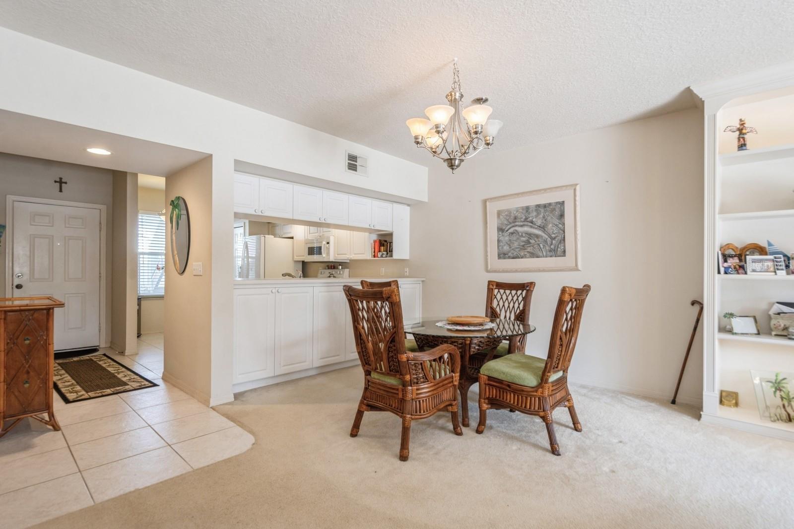 Kitchen open to dining area in living room. Tons of natural light