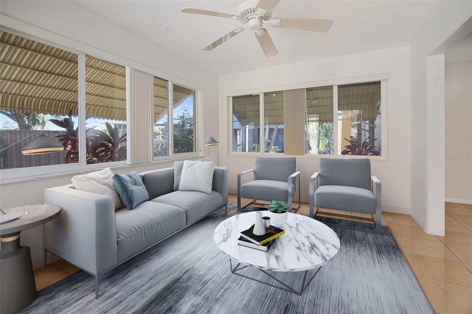 Family room Lots of natural light opens to screened lanai with views of the Lake. Virtual Staging.
