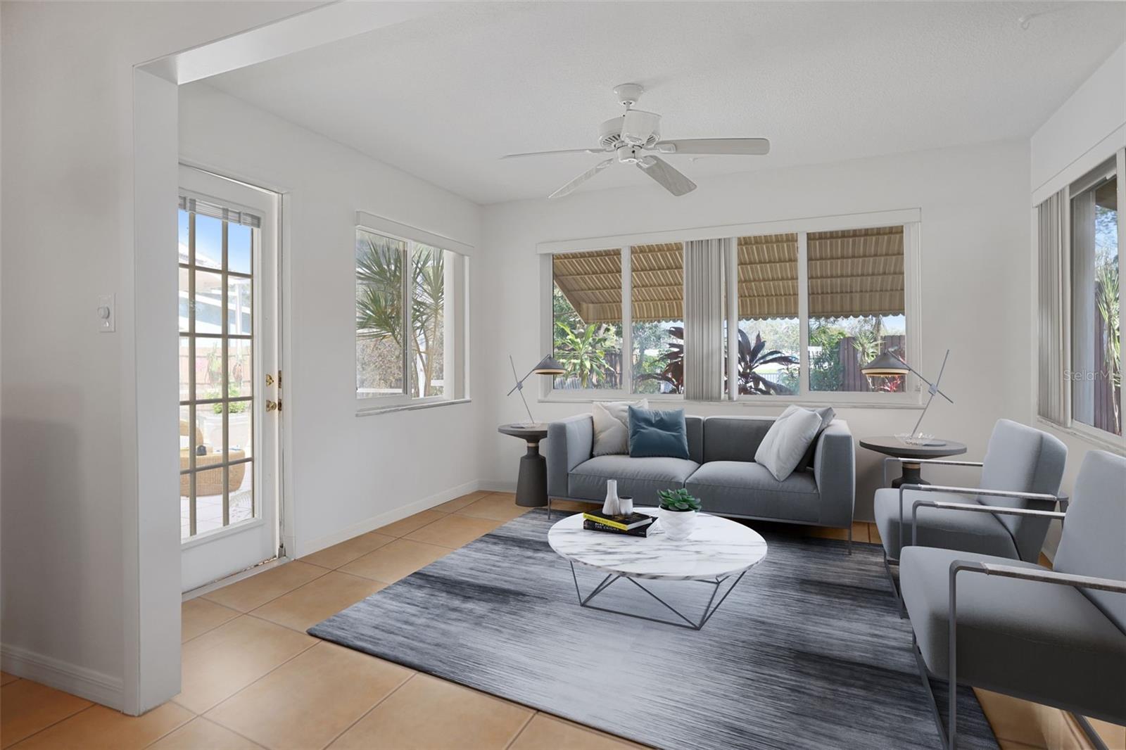 Family room Lots of natural light opens to screened lanai. Virtual Staging.