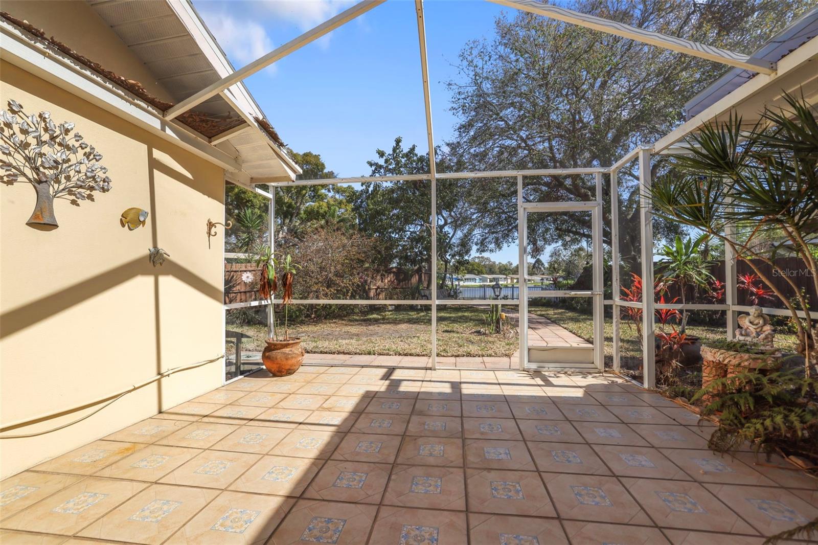Screened lanai with view through to the lake and the backyard