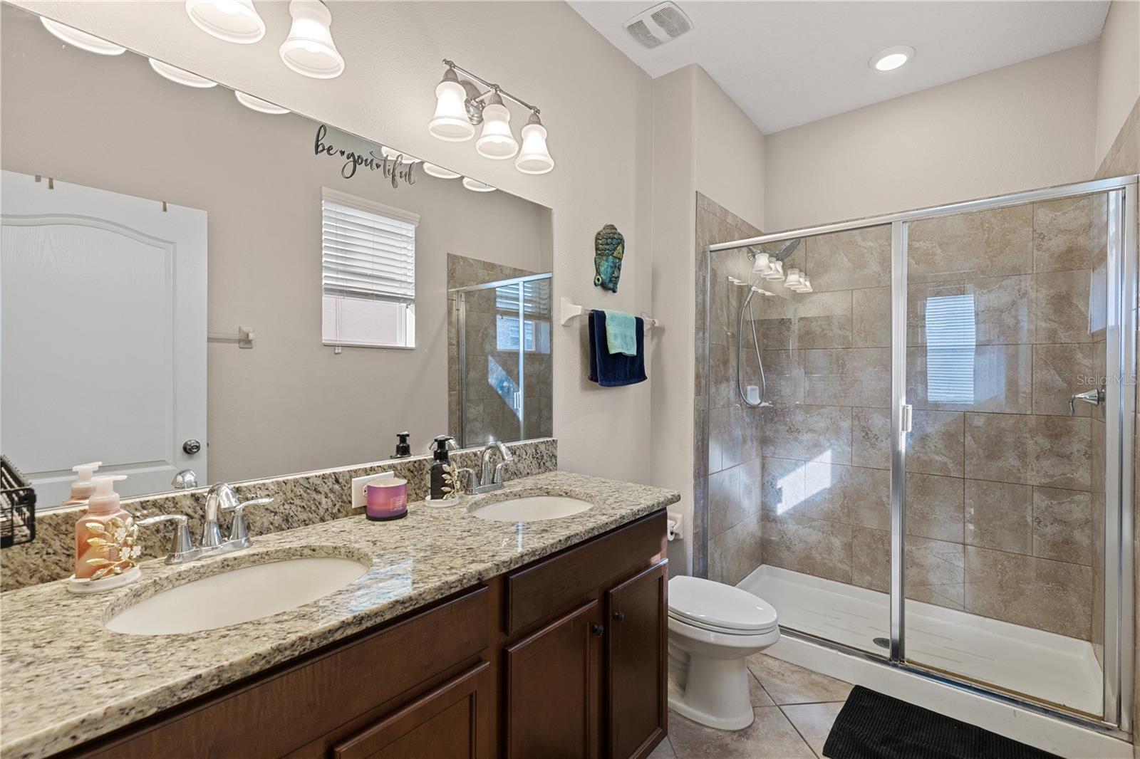 Duo sinks and walk-in shower in the primary bathroom