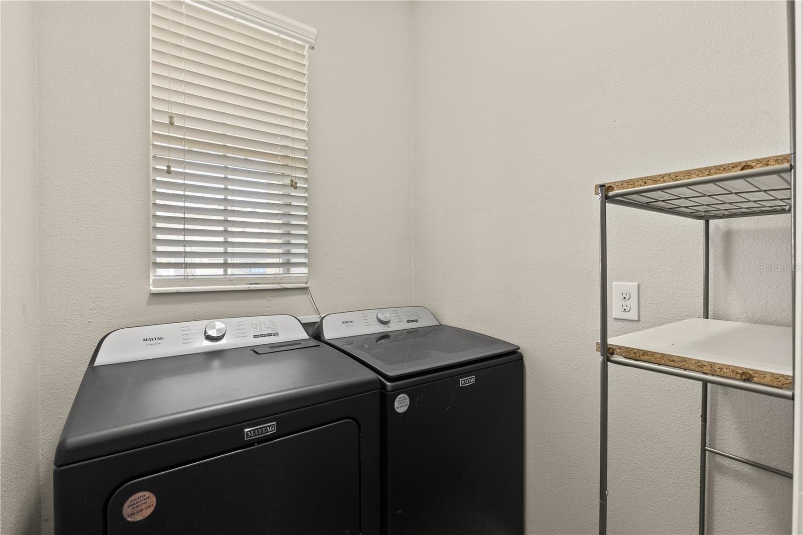 A dedicate laundry room with a newer washer and dryer featuring a pet hair removal system.