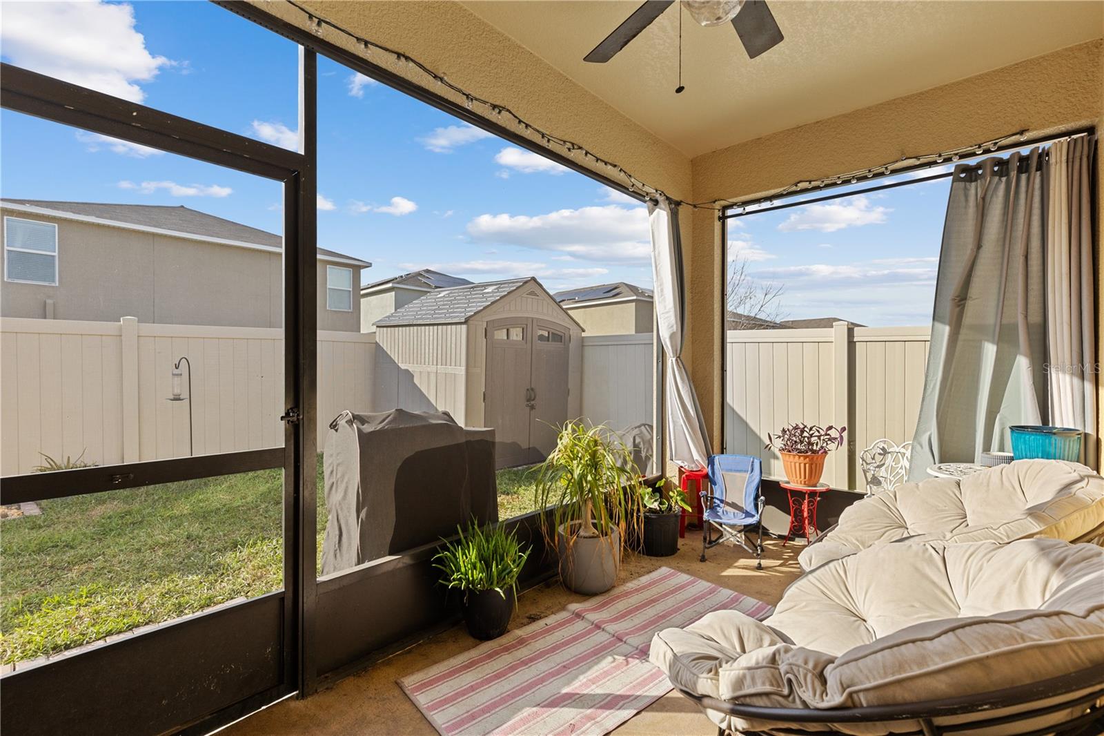 Featuring this screened-in lanai and fenced backyard with a 7x7 storage shed.