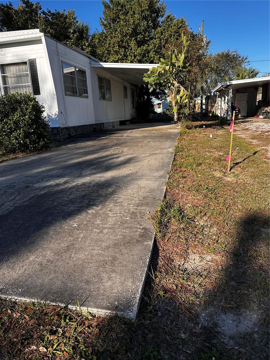 Carport area with survey stick.