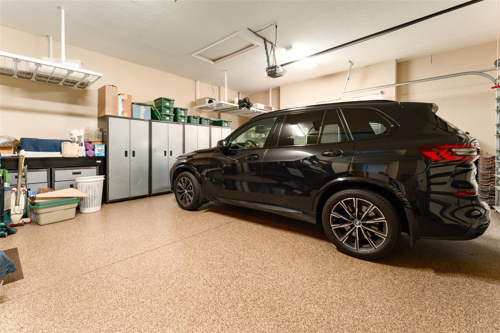 2 Car Garage Bay with Epoxy Flooring & Built in Ceiling Storage Racks. The 3rd Bay Garage is  opposite to Double Garage