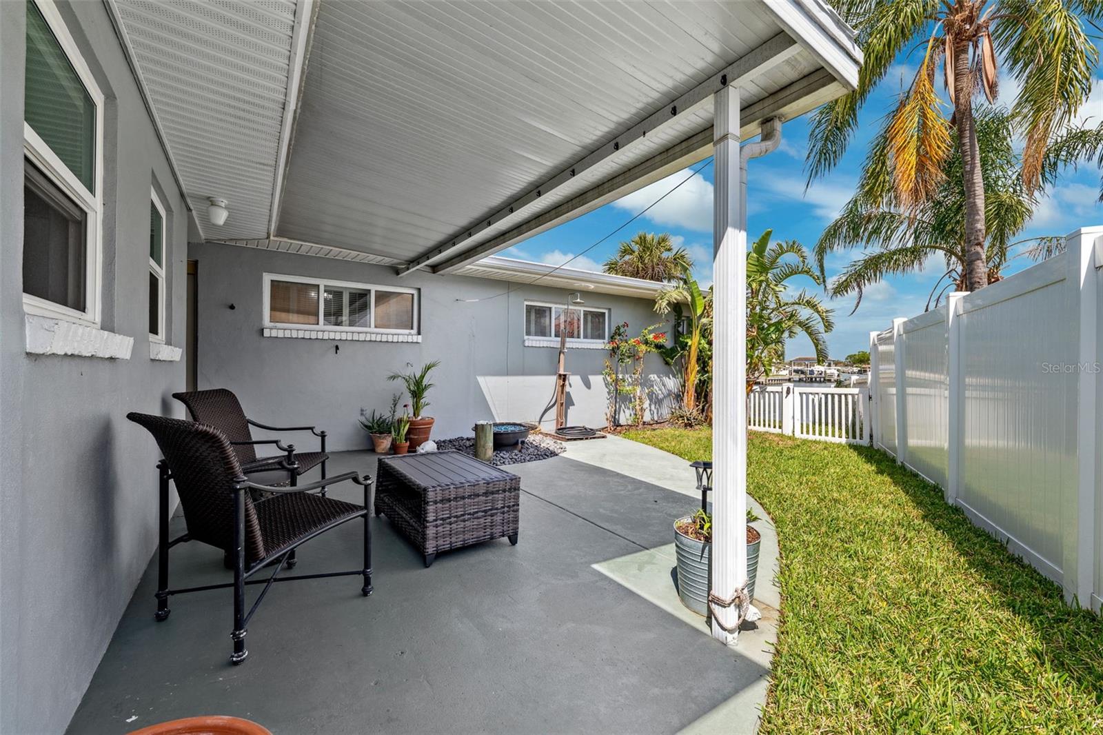 Rear side patio and fenced in petite yard
