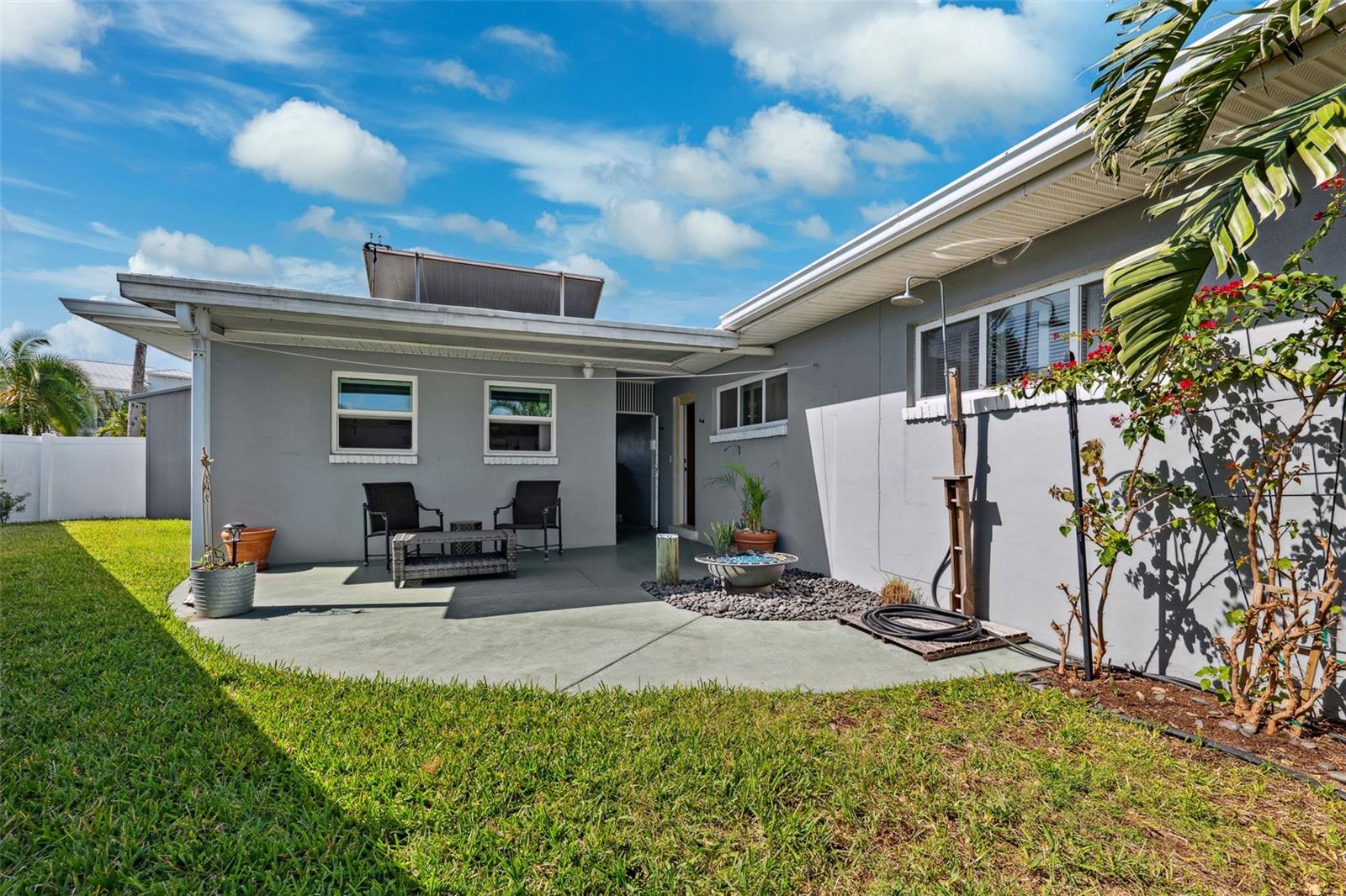 Rear side patio and fenced in petite yard