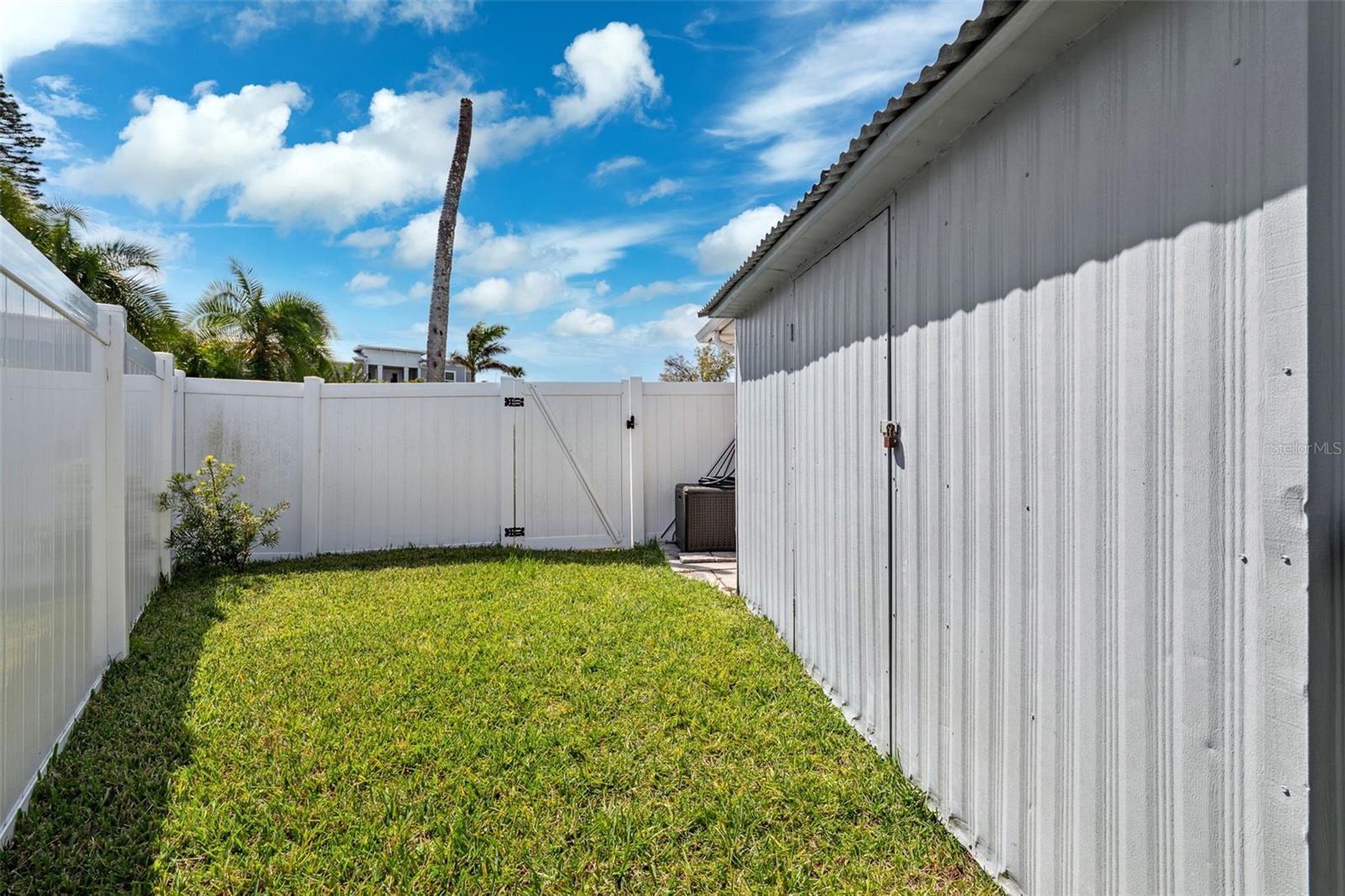 Storage sheds tucked on the side of the garage