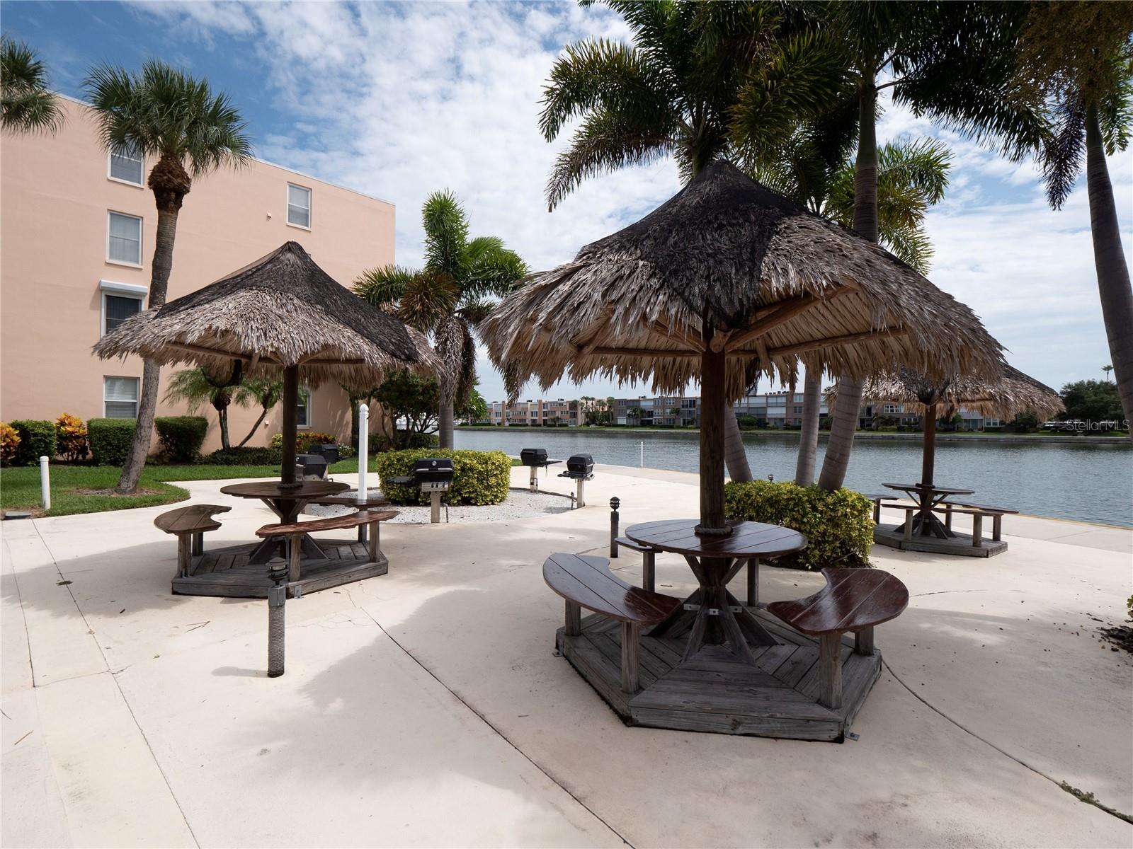 Waterfront tiki area with grill access