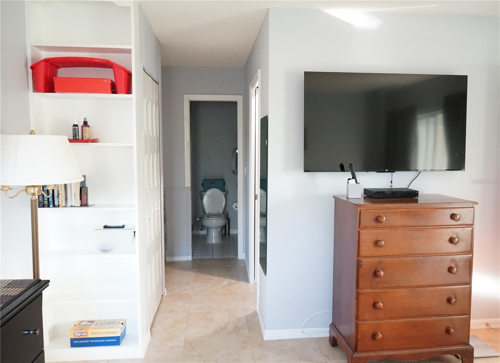 primary bedroom hallway to vanity and walk in closet