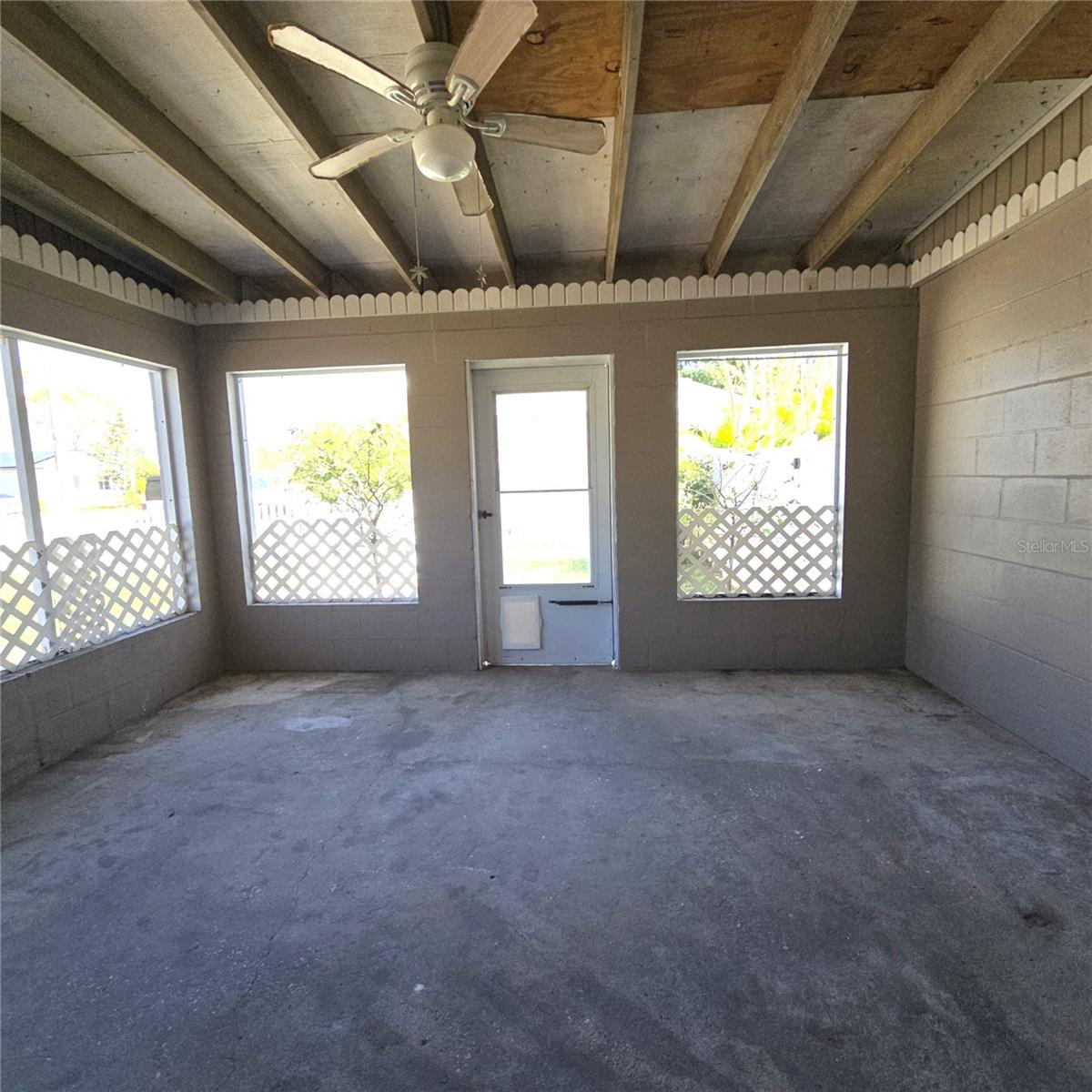 enclosed porch has pet door leading out to fenced courtyard