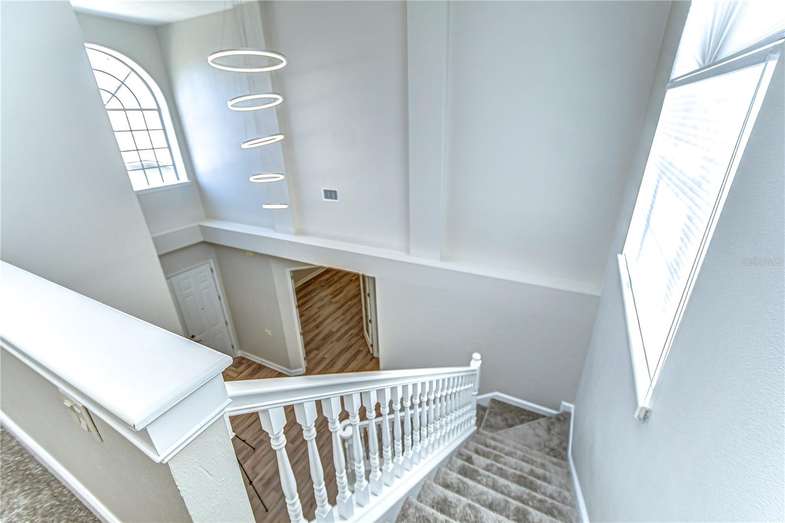 Bright and welcoming, this stunning staircase features modern lighting and elegant railings, guiding you to explore the heart of your new home.