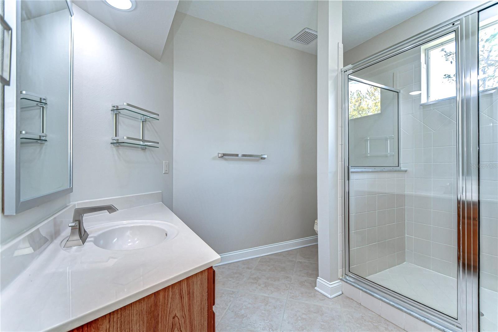 . Enjoy a spacious shower, sleek fixtures, and chic finishes that create a serene escape right at home.