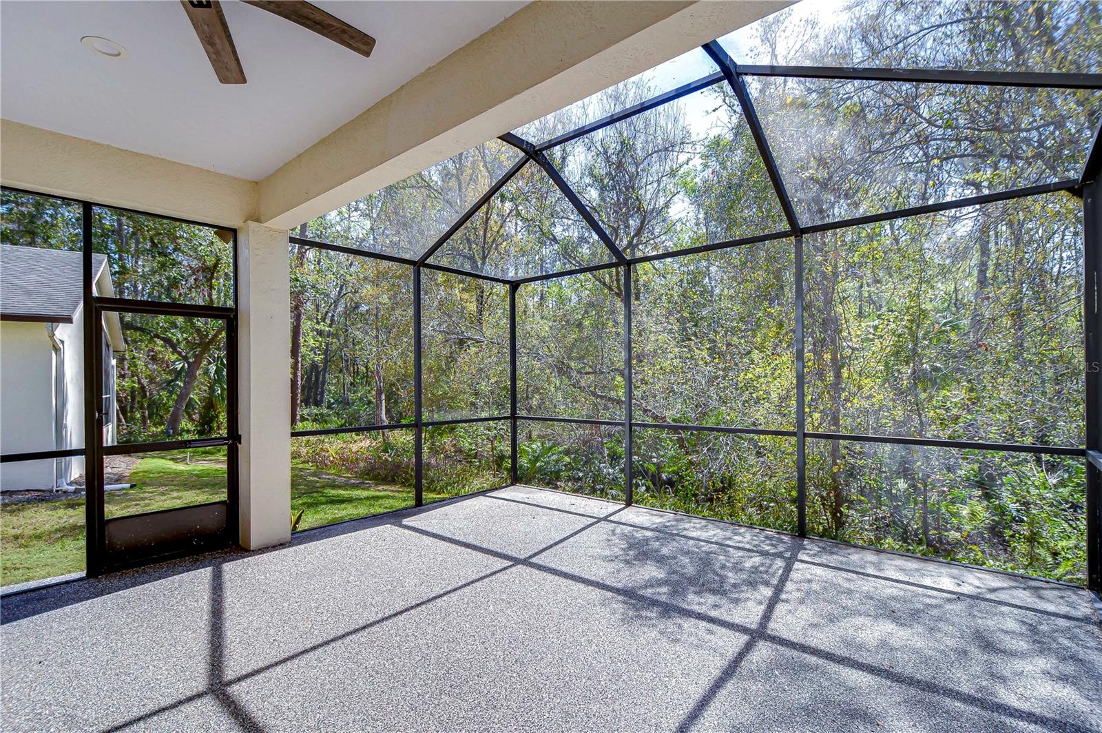 Enjoy serene mornings in this screened lanai, where nature becomes your tranquil neighbor. Perfect