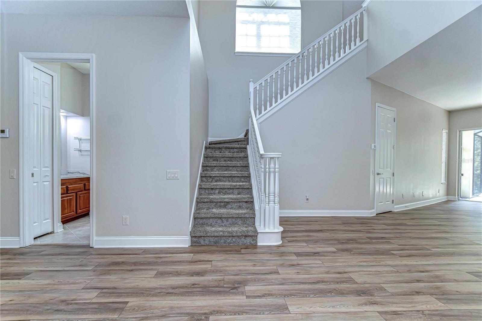 Step into elegance with this home’s inviting foyer and graceful staircase.