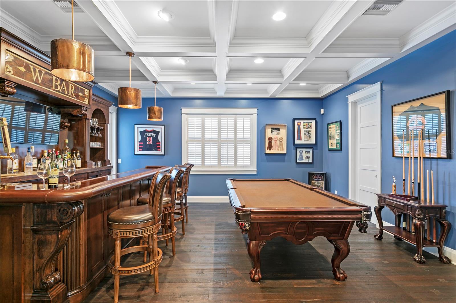 Loser buys the next round . . . . A custom bar/game room with 2 tap-keg system, wine cooler, LED lighting, Scotsman nugget cube icemaker, adjacent to the Great Room and Kitchen.