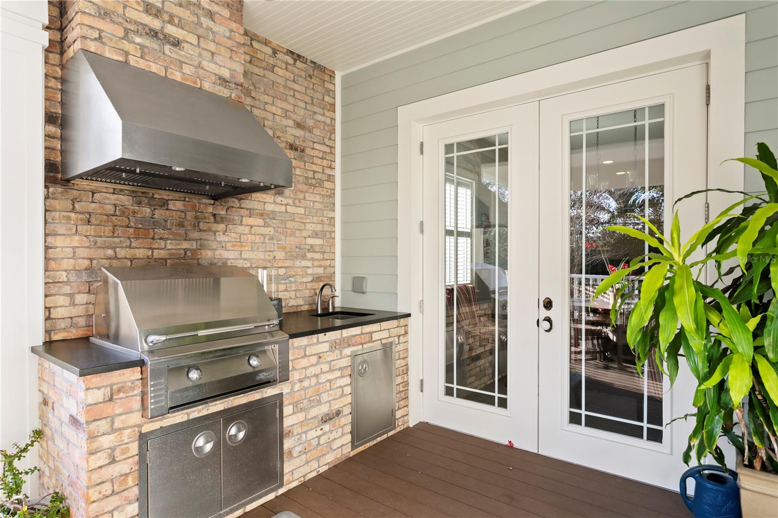 The dining Area has oversized large French doors that open to a splendid, covered lanai, with outdoor kitchen, roomy enough for Alfresco dining, and overlooks the lushly landscaped yard