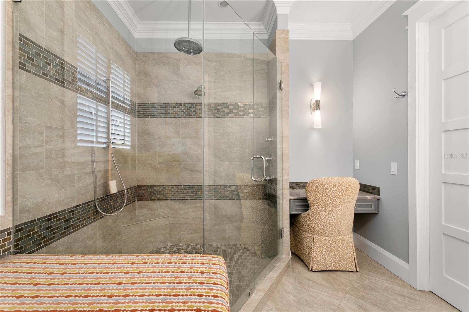 a luxurious master bathroom with oversized dual control walk-in shower, oversized tub, dual vanities with elevated fixtures