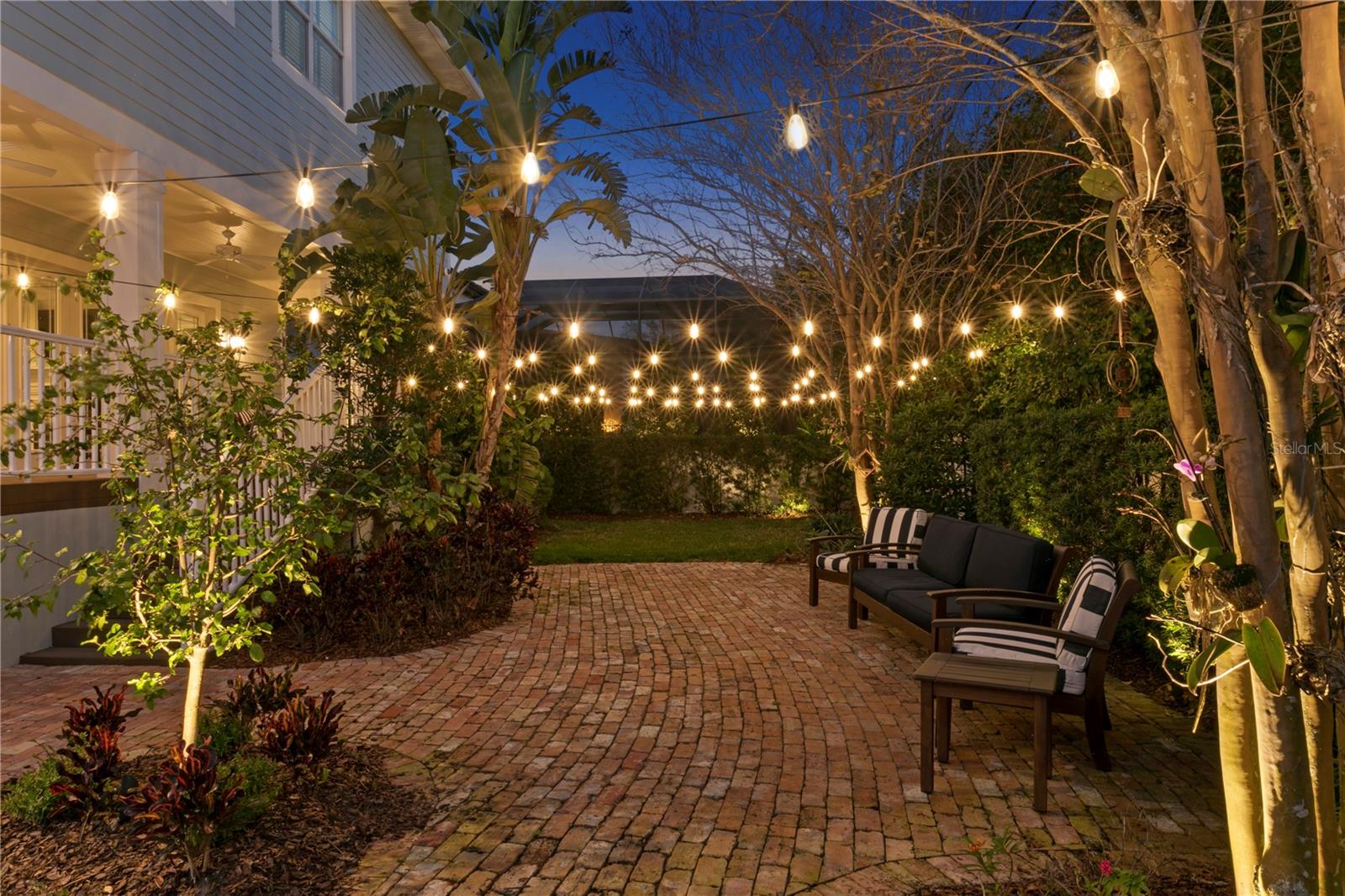 Lovely rear patio (ground level) with bistro lighting make a great place for evening parties.