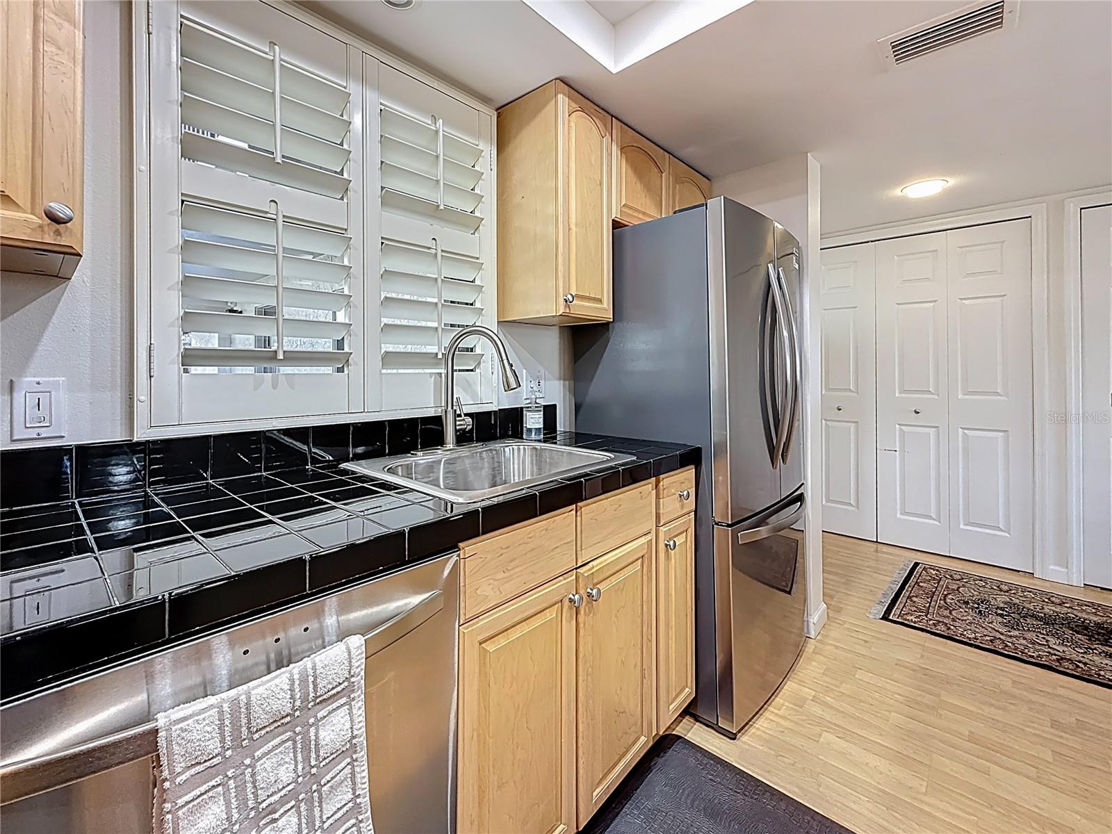 A closet opposite the kitchen provides room for pantry storage, ironing board and washer/dryer.