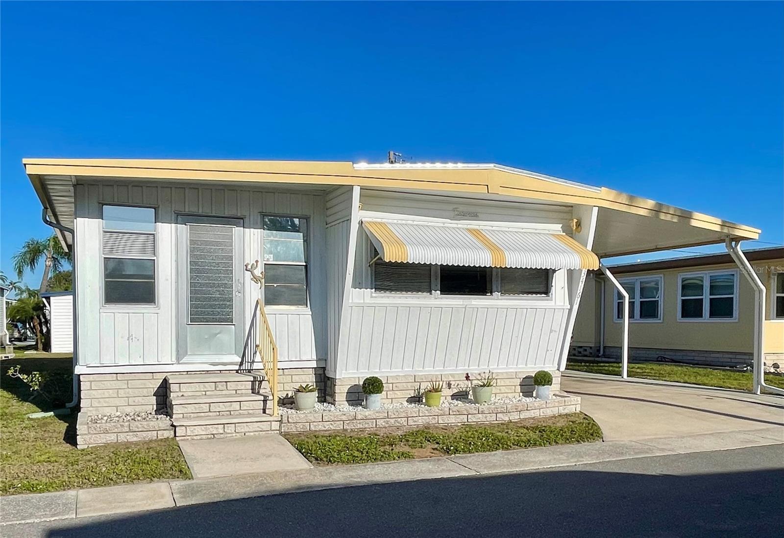 Roof-over installed in 2024, AC in 2018... carport extensions on the driveway. Front door needs some work.