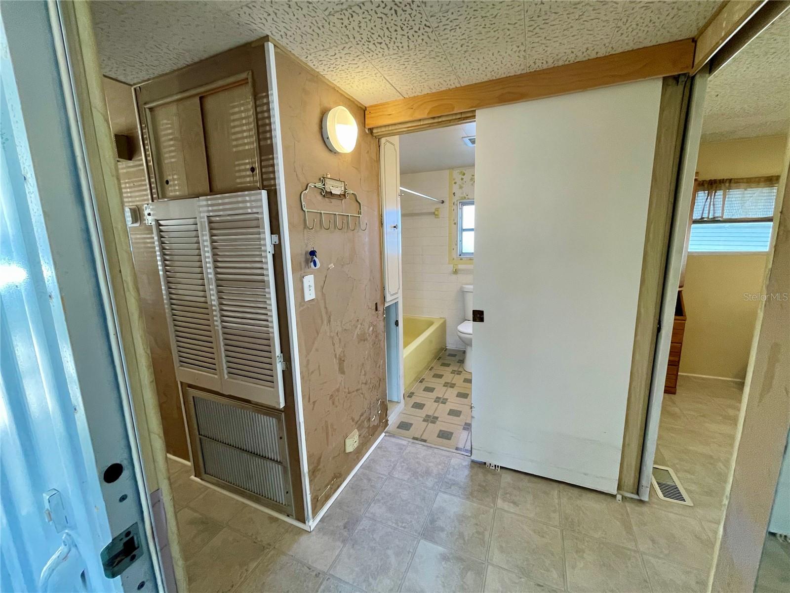 Entering home from the Lanai - Main bedroom to the right, hall bath straight ahead.