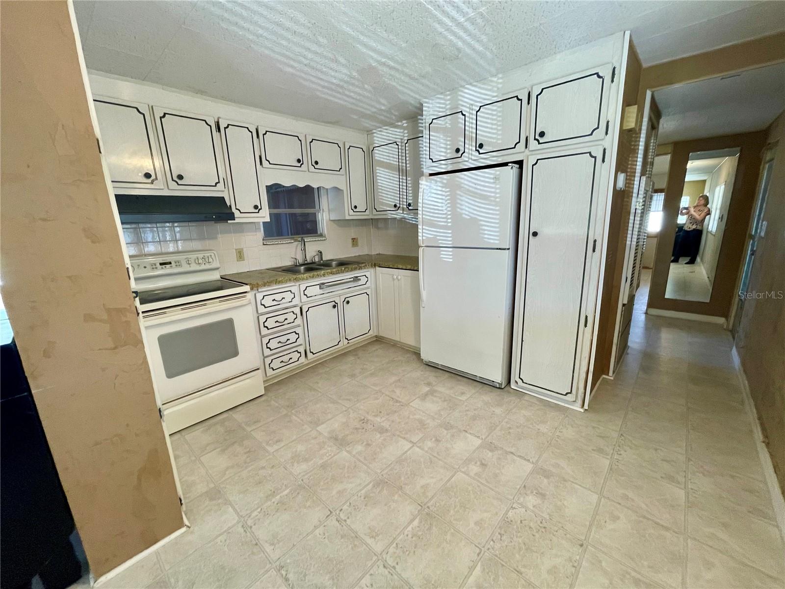 Kitchen, includes a pantry, some paint would wake those cabinets up!