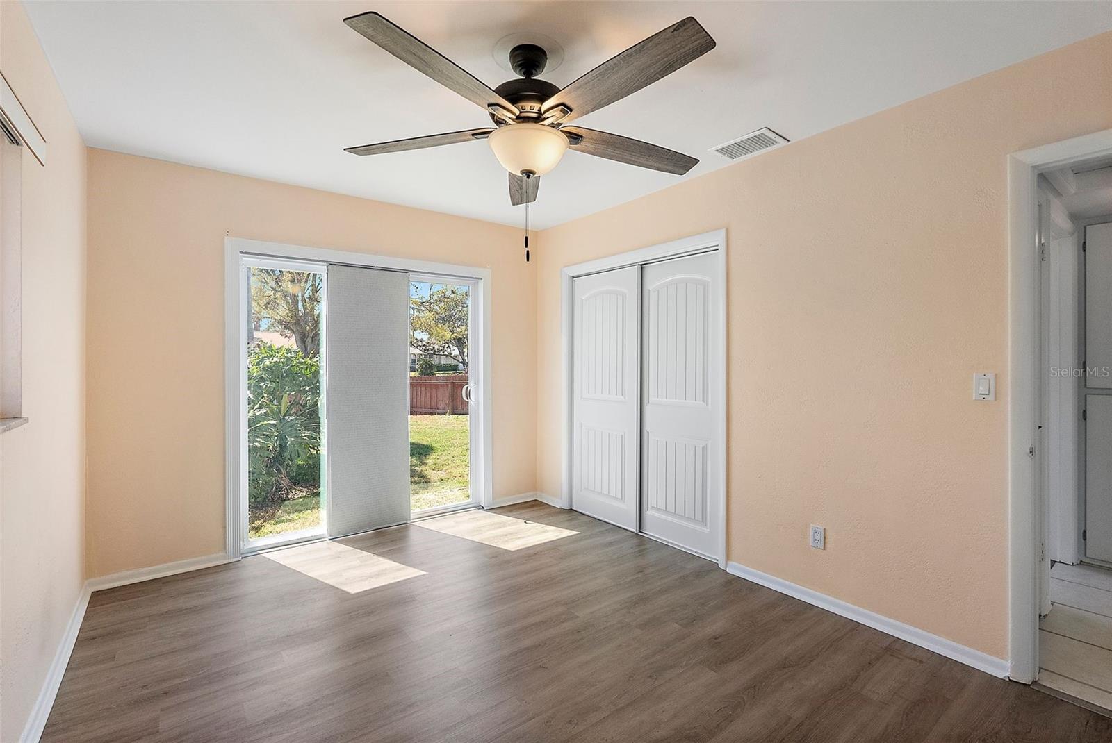 MASTER BEDROOM WITH SLIDING DOOR TO PRIVATE FENCED SIDE YARD.