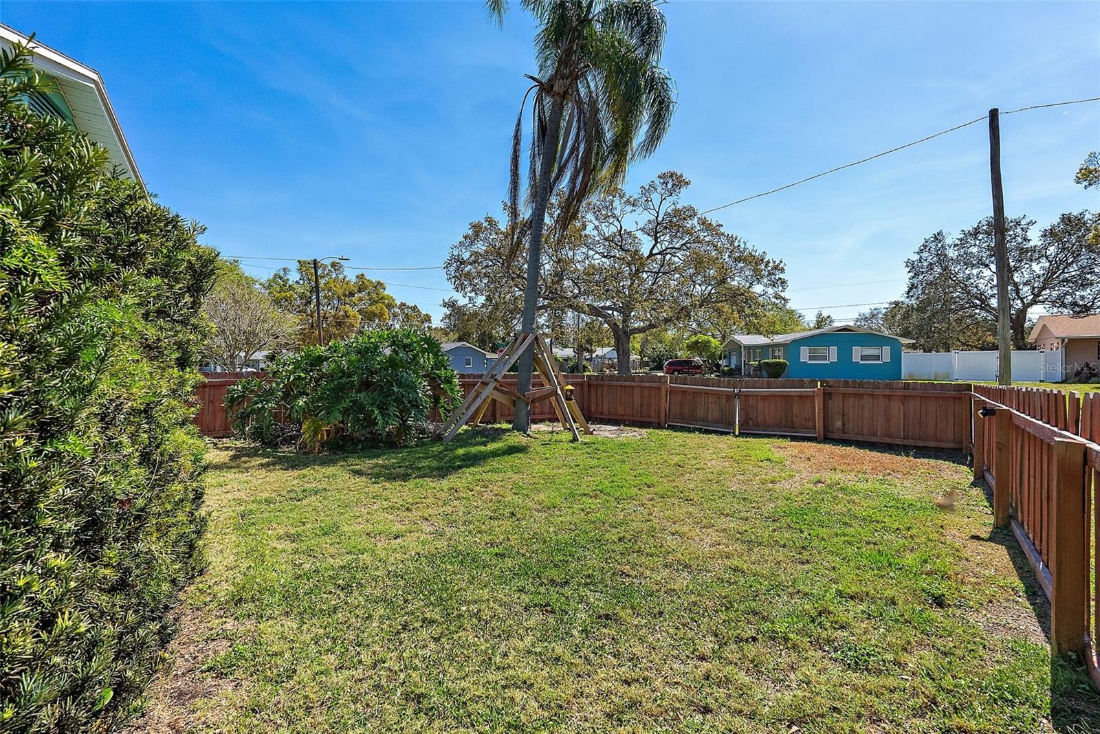 LARGE FULLY FENCED YARD DIRECTLY OFF OF PEBBLED SIDE YARD - A GARDENERS DREAM