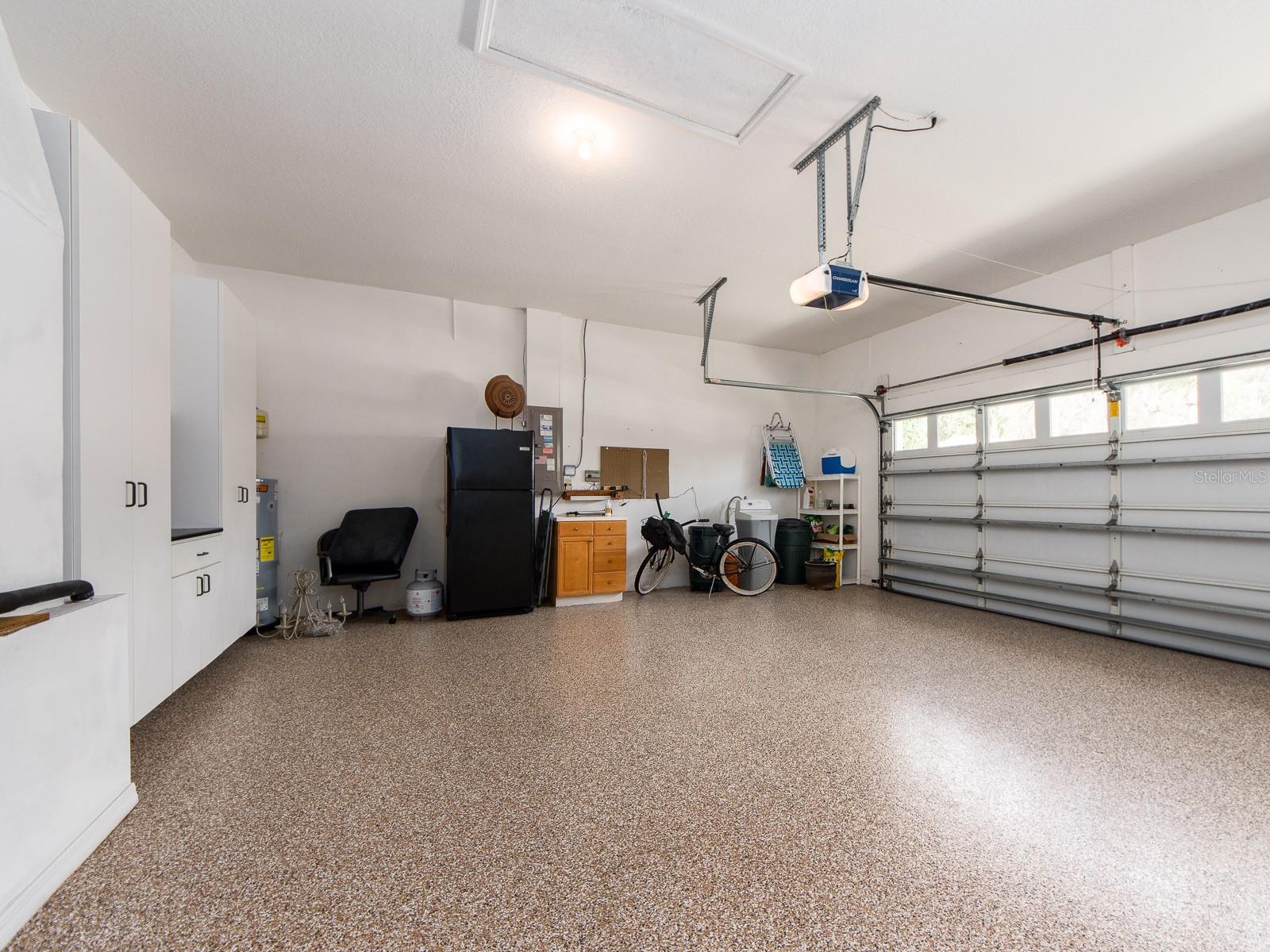 OVERSIZED 2 CAR GARAGE WITH BUILT IN STORAGE CABINETRY AND HIGH QUALITY EPOXY FLOOR FINISH.