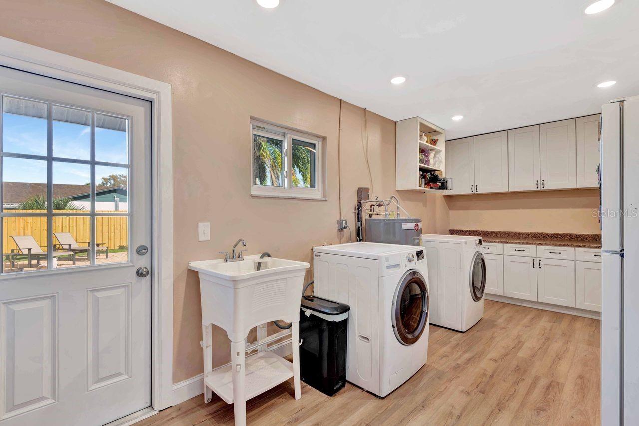 Such a special laundry room with so much storage.