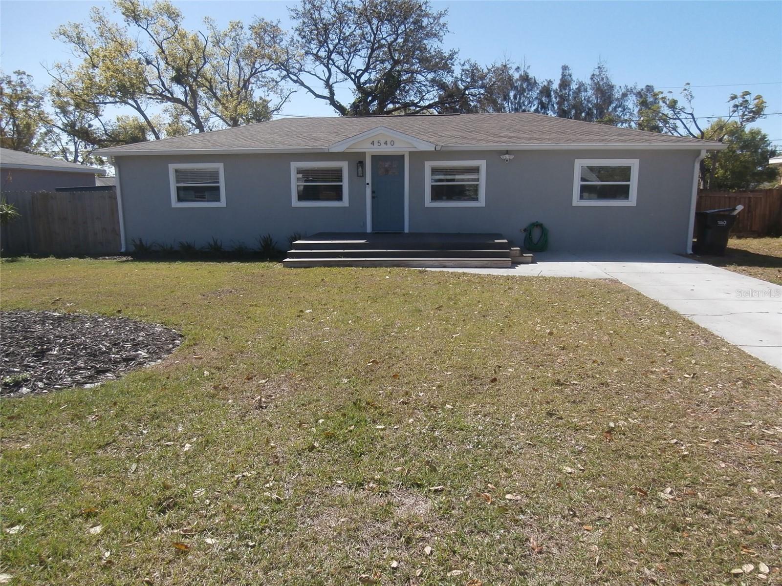 Front with porch & extended driveway.