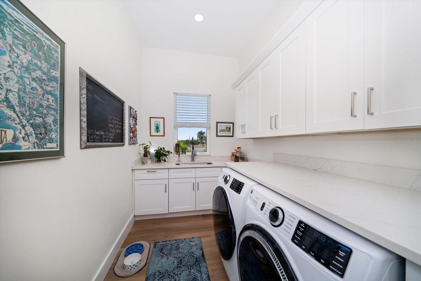 Laundry room, complete with plenty of storage and laundry sink