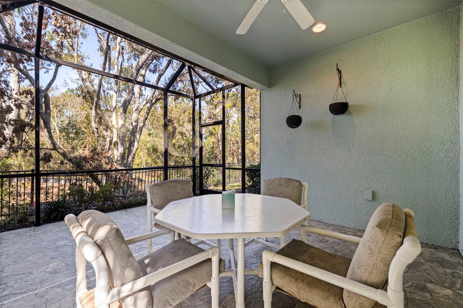 Screened-in oversized back porch with ceiling fan