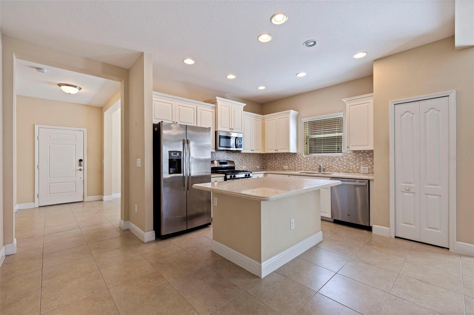 Kitchen with Pantry, Corian counters, and gas stove