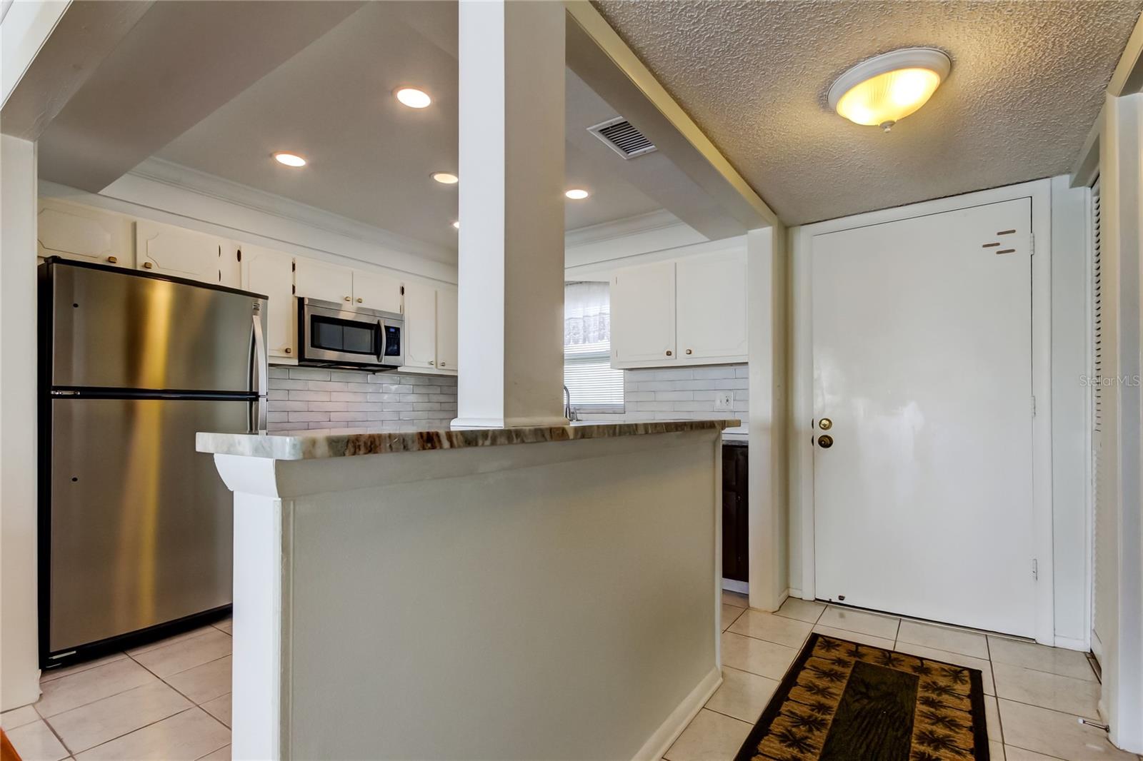 The tray ceiling adds height and volume to the kitchen.  Recessed lighting is a plus!