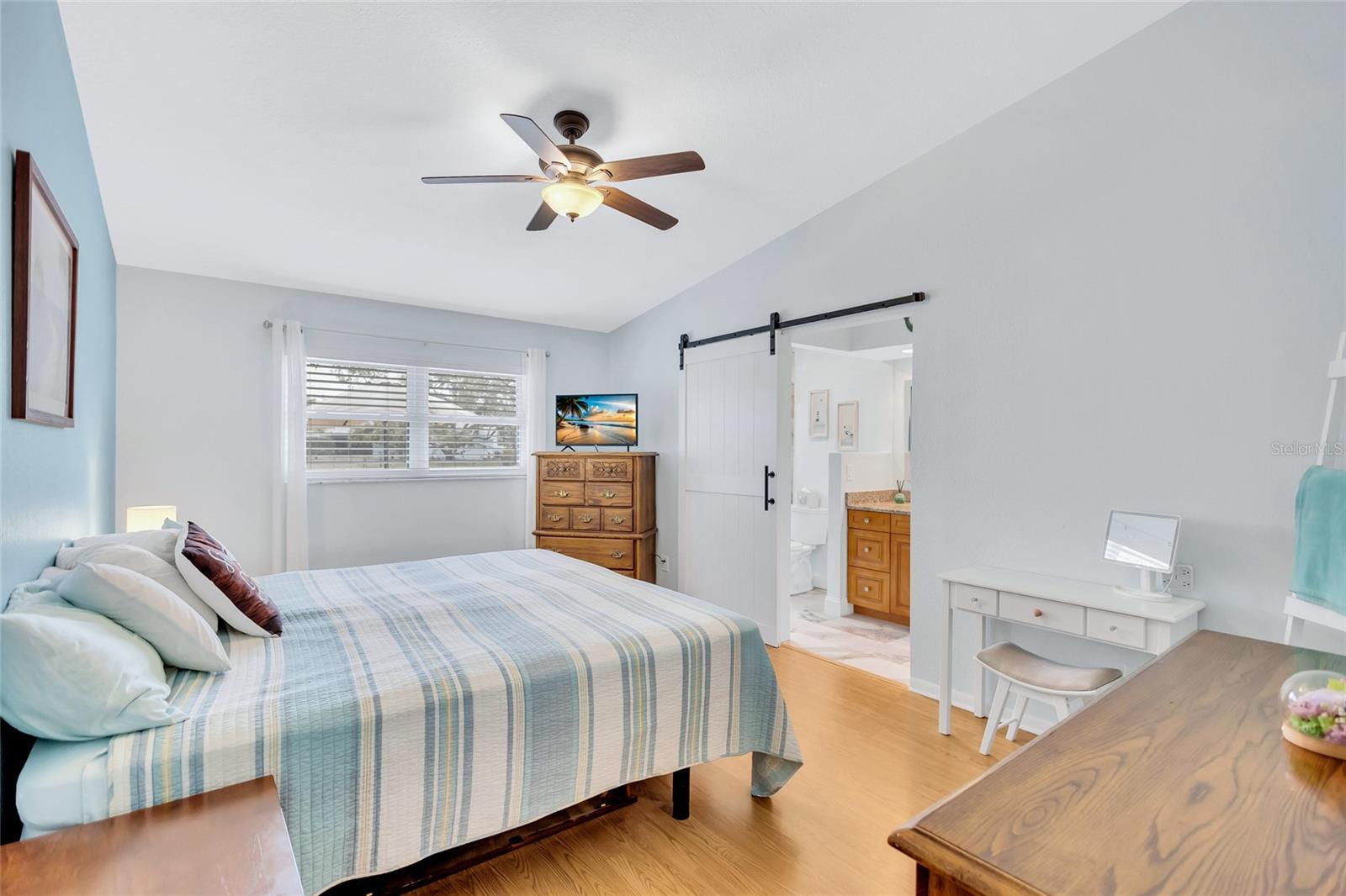 Primary bedroom with vaulted ceilings