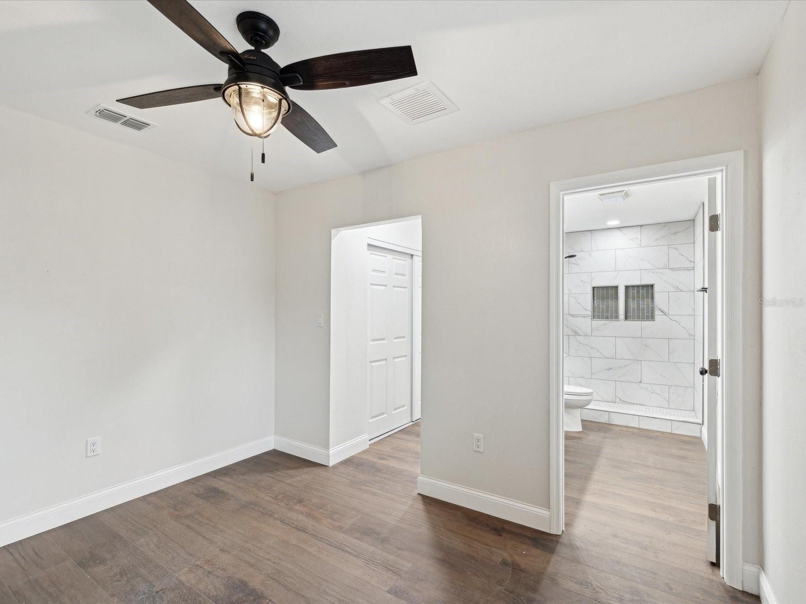 Primary bedroom with bathroom suite