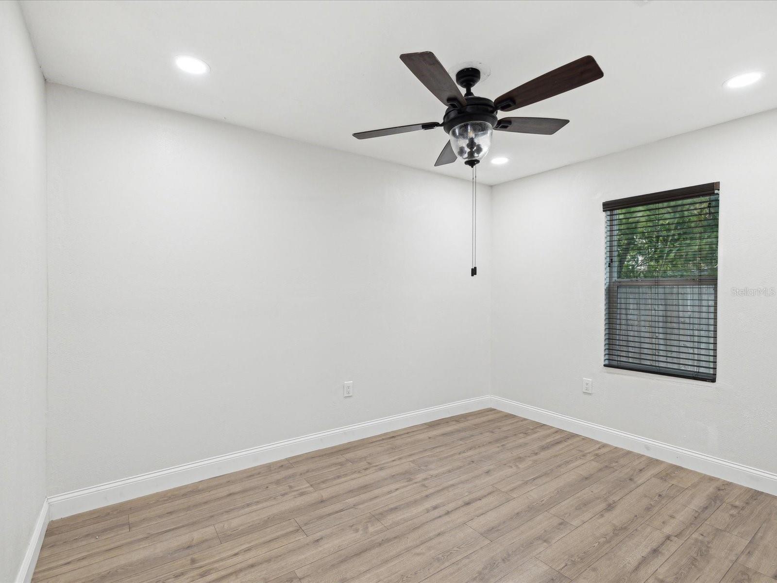 Second bedroom with light dimmers and a fan/light