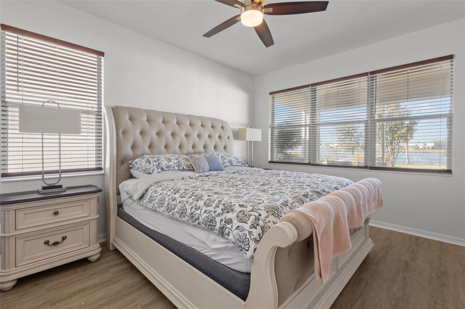 Master suite overlooks lush backyard and pond