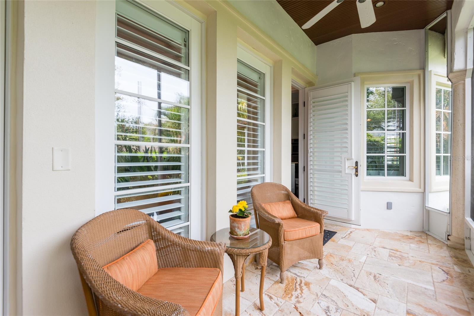 porch towards front/side of home with an interior access door and storage room