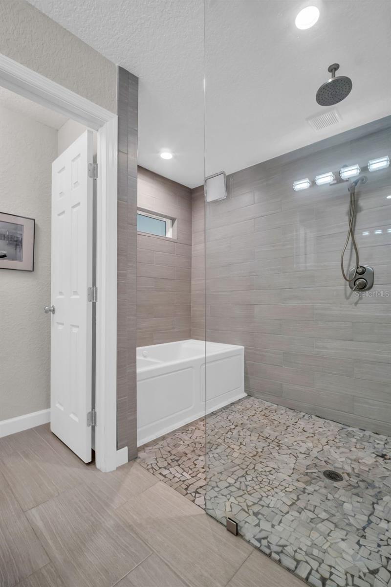 The enlarged master en-suite is a true masterpiece with a relaxing jacuzzi tub & walk-in shower~