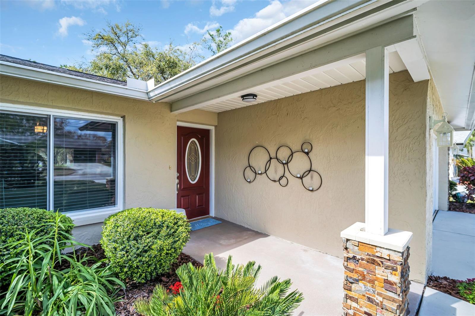 Gracious covered entry & landscaping~