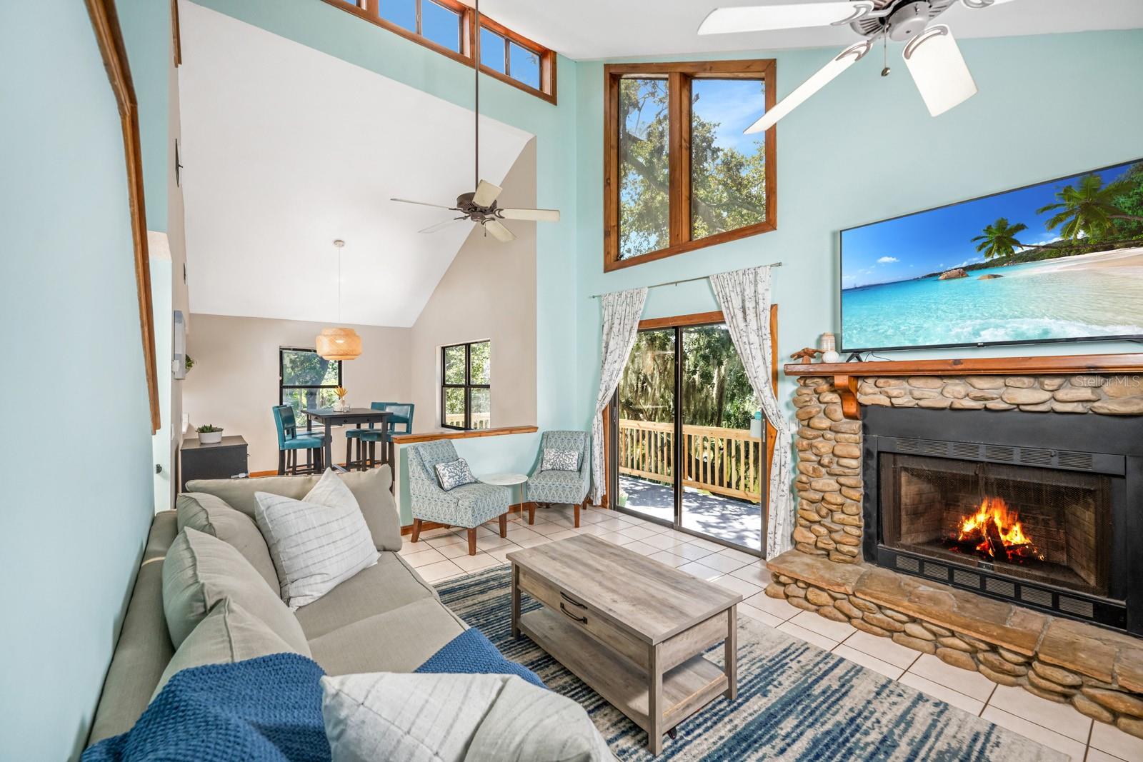 Family/great room showcasing wood burning fireplace.