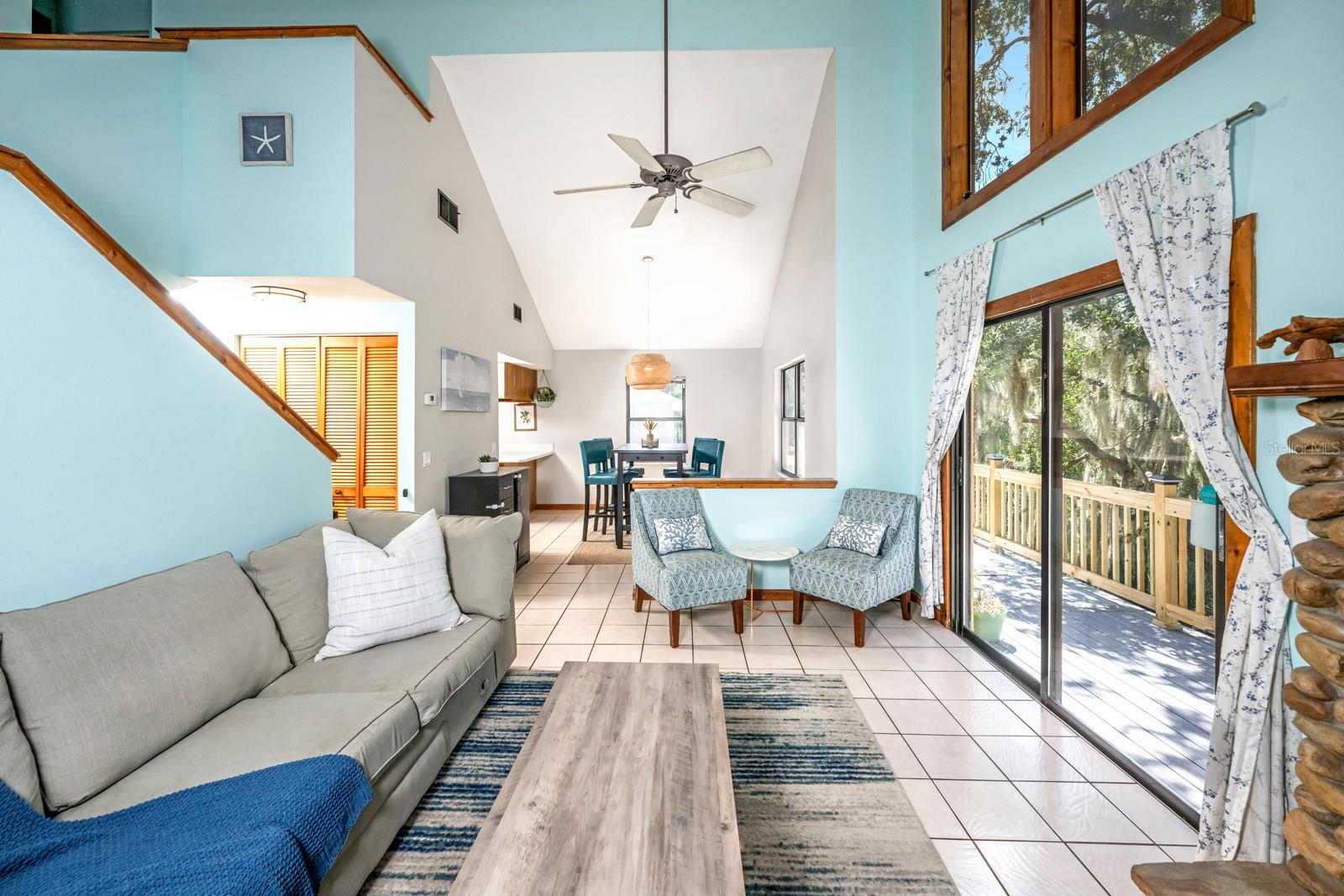 Main family room with sliders and picture window letting in lots of natural light