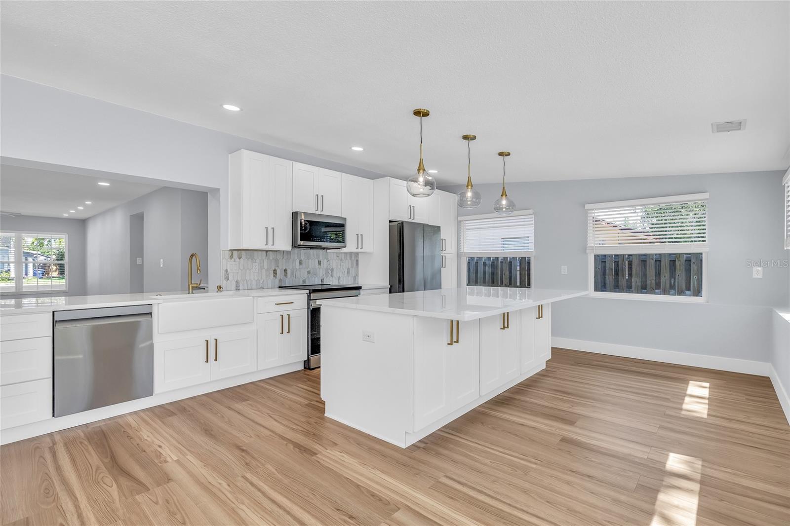 Custom Kitchen with SS Appliances and Brass Hardware