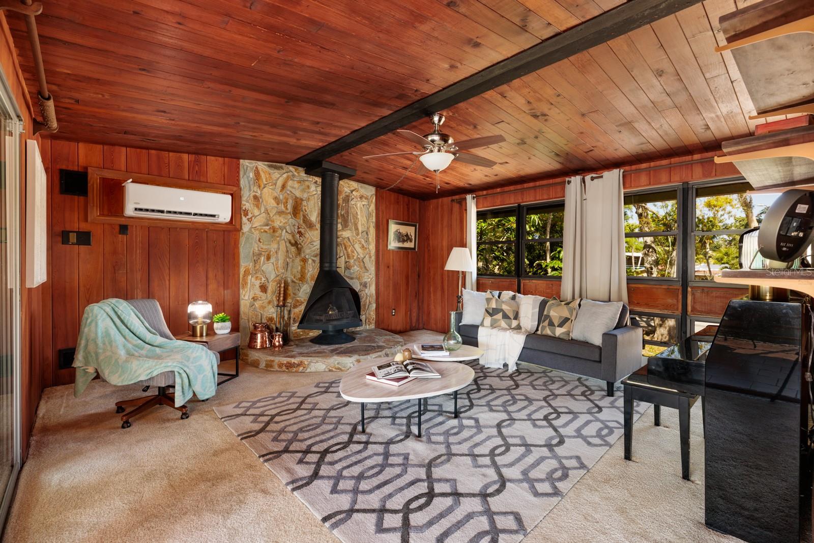 Living Room with Malme woodburning fireplace and awning windows w/outdoor planters